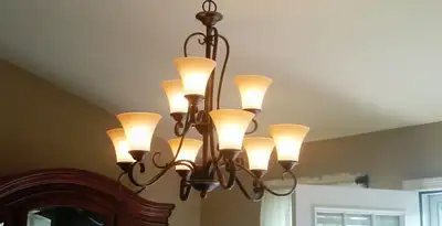 Classic ceiling chandelier installation with warm lighting in Cincinnati, OH
