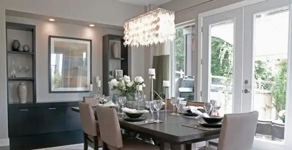 Elegant dining room chandelier installation above table in Cincinnati, OH
