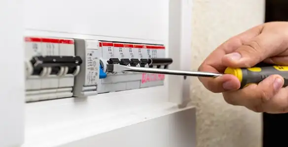 electrical panel upgrade service showing technician adjusting circuit breakers during system upgrade in Cincinnati, OH