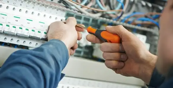 electrical service showing licensed electrician performing electrical panel maintenance and adjustments in Cincinnati, OH