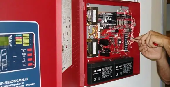 fire alarm installation service showing technician configuring fire alarm control panel in Cincinnati, OH