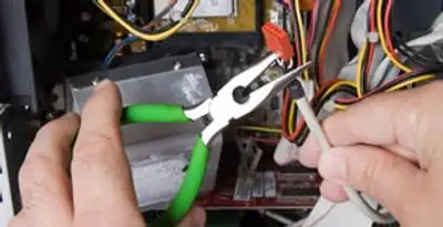 Licensed electrical contractor performing electrical repair with tools in Erlanger, KY
