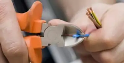 professional electrical services showing precise wire cutting by licensed electricians in Cincinnati, OH