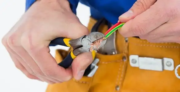 licensed electrician securing electrical wiring with professional tools during service work in Cincinnati, OH