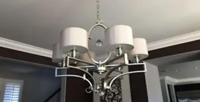 Modern chandelier installation with multiple light fixtures in Cincinnati, OH